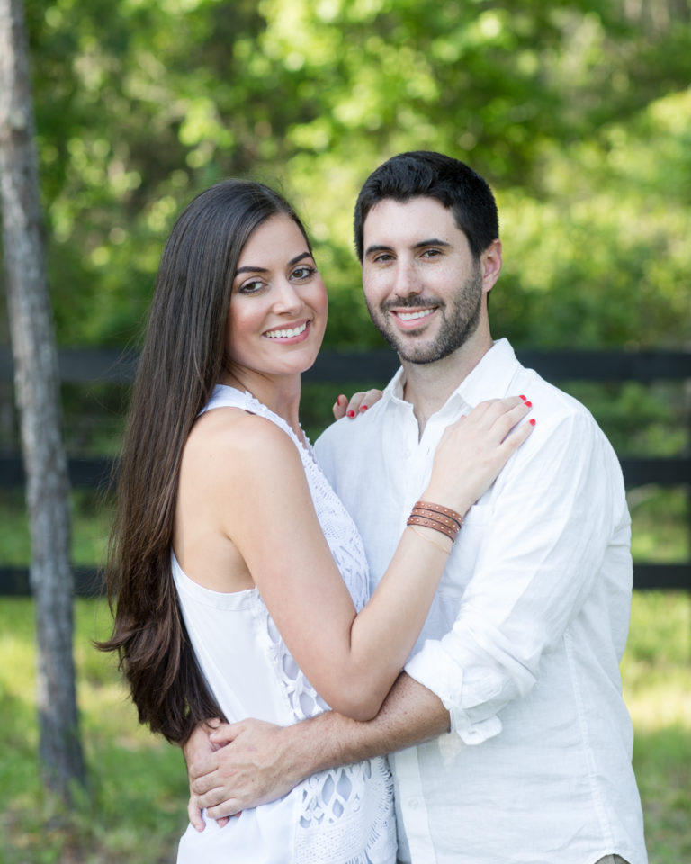 Gorgeous married couple dark hair dressed all in white light filled outside photo Williston Florida