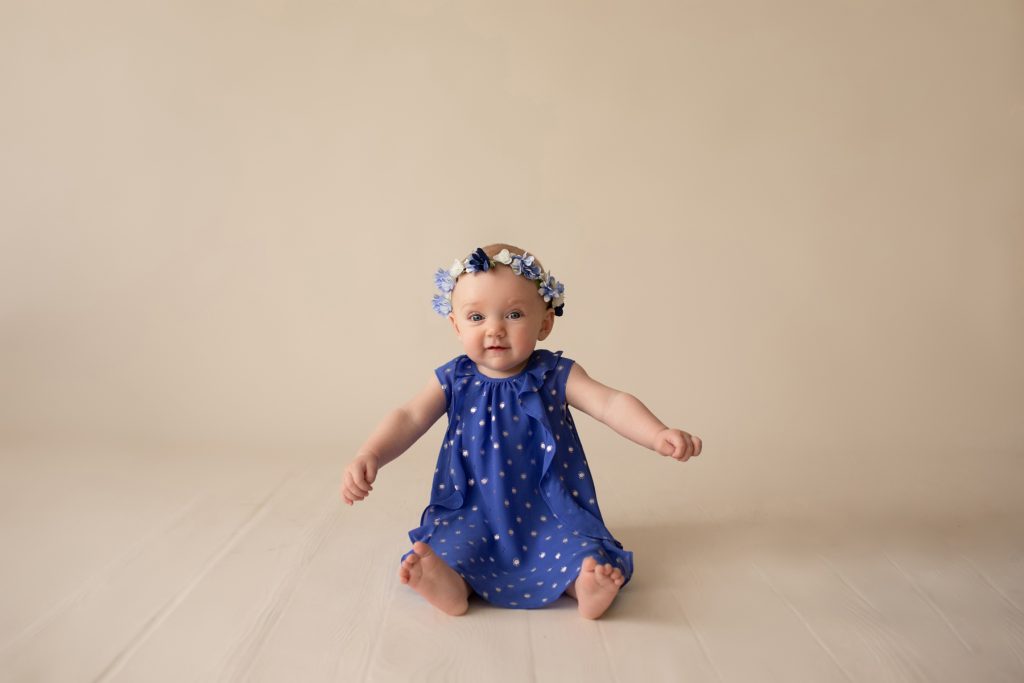 beautiful baby photos 6 month girl wears blue polka dot dress and floral crown